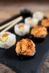Sushi roll set on the black plate. Japanese food.