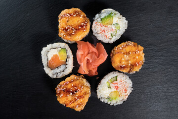 Sushi roll set on the black plate. Japanese food.