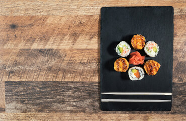 Sushi roll set on the black plate. Japanese food.