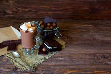Delicious chocolate smoothie with marshmallows on dark table