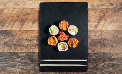 Sushi roll set on the black plate. Japanese food.