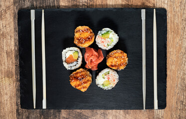 Sushi roll set on the black plate. Japanese food.