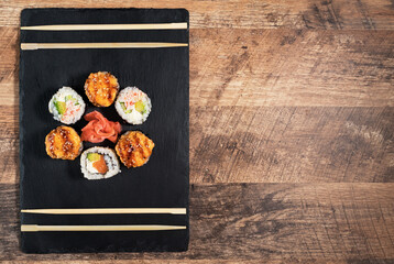Sushi roll set on the black plate. Japanese food.