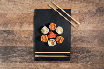 Sushi roll set on the black plate. Japanese food.