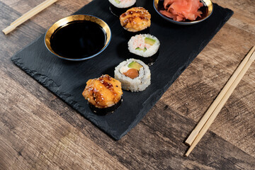 Sushi roll set on the black plate. Japanese food.