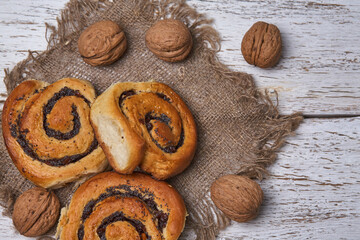 Tasty buns with raisins on a white rustic wooden table. fresh bakery. breakfast. bread. top view
