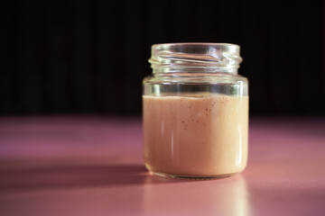Homemade yeast swells in a glass jar. Close-up.Concept photo.