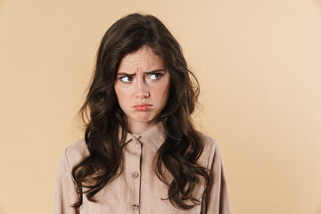 Image of resentful brunette woman posing and looking aside