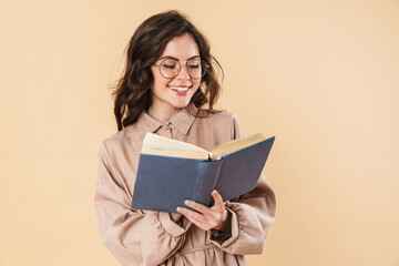 Image of smiling caucasian woman in eyeglasses reading book