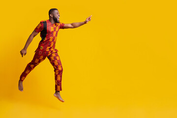 Excited black man running towards copy space for advertisement