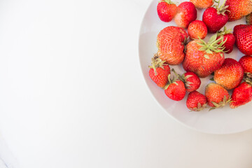  Tasty ripe strawberries on the table, summer seasonal healthy red berry on a white plate