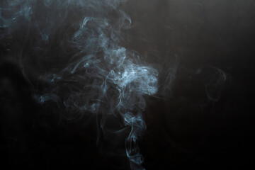 Figured smoke on a dark background. Abstract background, design element, for overlay on pictures
