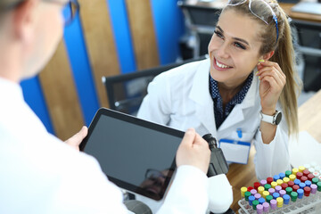 Portrait of smiling laboratory assistant looking at colleague with gladness and calmness. Workers...