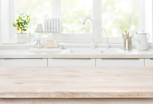 Wooden table on blurred backgrounds of kitchen white sink window