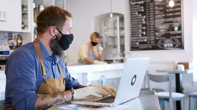 Coffee shop owners with face masks, lockdown, quarantine, coronavirus, back to normal concept.