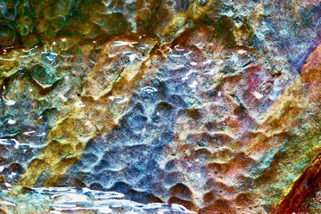 natural abstract spotted multicolored texture of damp stone surface for background