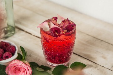 Closeup shot of a glass with raspberry lemonade with dried flowers
