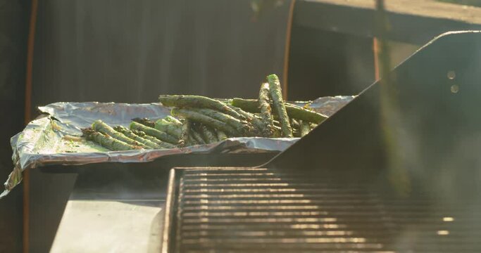 Fresh asparagus cooking on a bbq grill on a summer afternoon