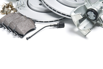 brand new brake discs, brake caliper and brake pad set for car. isolated on white with copy space.