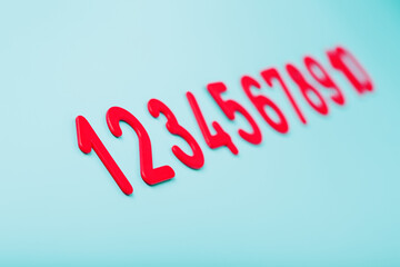 Red numbers on a blue background in a row from one to ten.