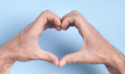 Male hands in shape of heart.