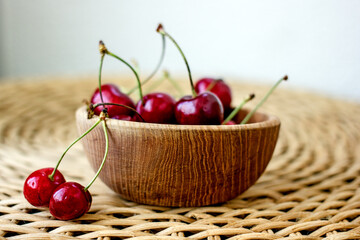 Tasty ripe cherry on a light wooden table, copy space