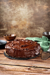 Vegan chocolate cake on wooden background