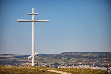 A large metal cross of worship stands on a hill at the site of the founding of the Cossack village
