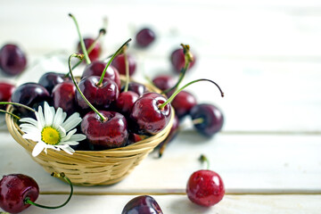 Tasty ripe cherry on a light wooden table, copy space