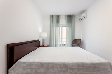 Minimalistic bedroom in bright colors and white walls. European style.