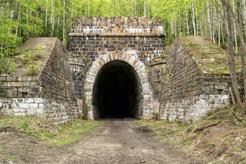 Fototapeta na wymiar old abandoned railway tunnel, stone-lined tunnel entrance