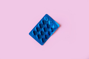 Pill packaging on pink background. Tablets. Close-up.