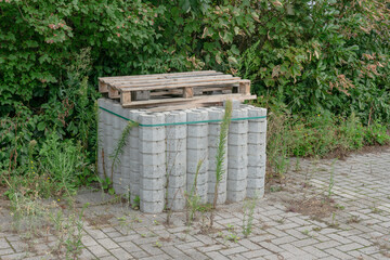stack of hexagonal concrete bricks with wooden pallets on them