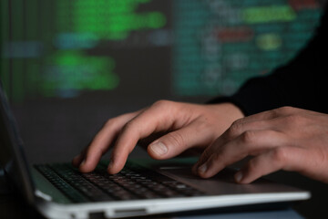 Male hands typing computer code, security program for database or servers