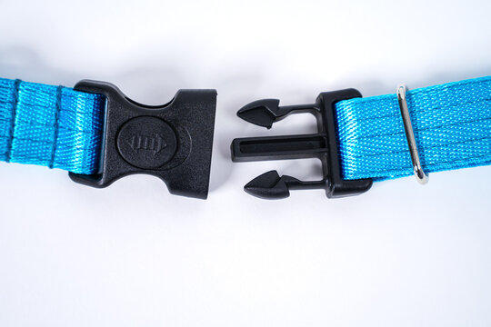 Side black release buckle from plastic with blue belt nylon on the white background.