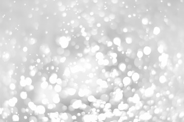 White glitter vintage lights background. White bokeh on black background.