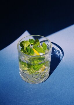 lemonade in crystal glass with fresh mint on blue background