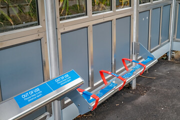 Naklejka premium Seating in the shelter on the rail platform at Brundall Gardens out of use during the 2020 Covid19 pandemic
