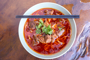 Kung fu noodles like spicy noodle with beef, vegetables and chinese sauce, Chinese traditional cuisine