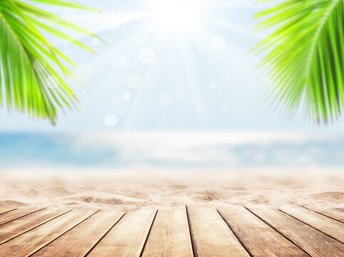 Wooden table top on blue sea and white sand beach background.