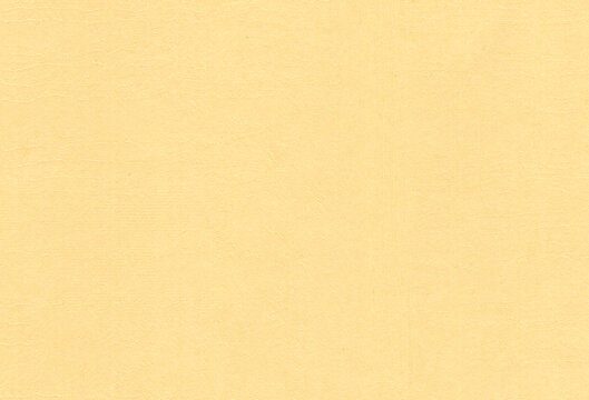 Textured pale orange coloured creative paper background. Extra large highly detailed image.
