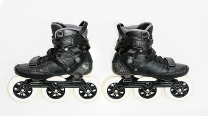 A pair of black inline skate boots on white background
