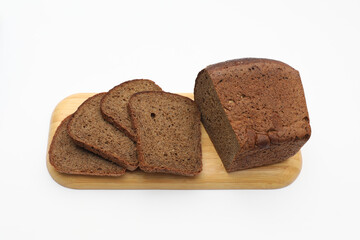 Rye bread on wooden cutting board on a white background