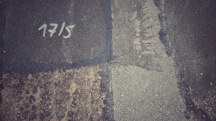 asphalt texture with white number