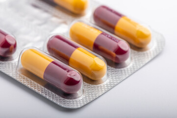 Heap of assorted various medicine tablets and pills different colors on white background. Copy space.