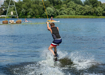 Wakeboard. Man surfing on the river on a board
