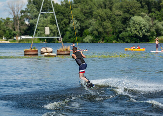 Naklejka premium Wakeboard. Man surfing on the river on a board