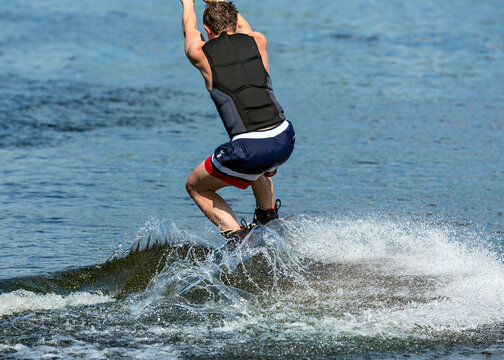 Wakeboard. Man surfing on the river on a board