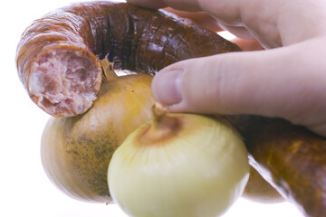 Reaching for a tasty sausage.