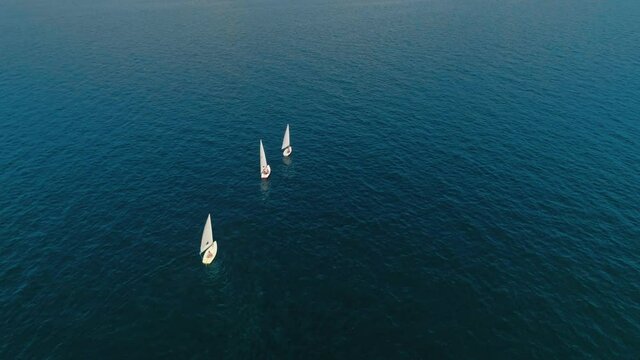 Group of young people on fancy sailing boats spend summer vacation at parties, exploration of amazing locations, sightseeing, sunny weather and crystal clear waters. Amazing travel idea